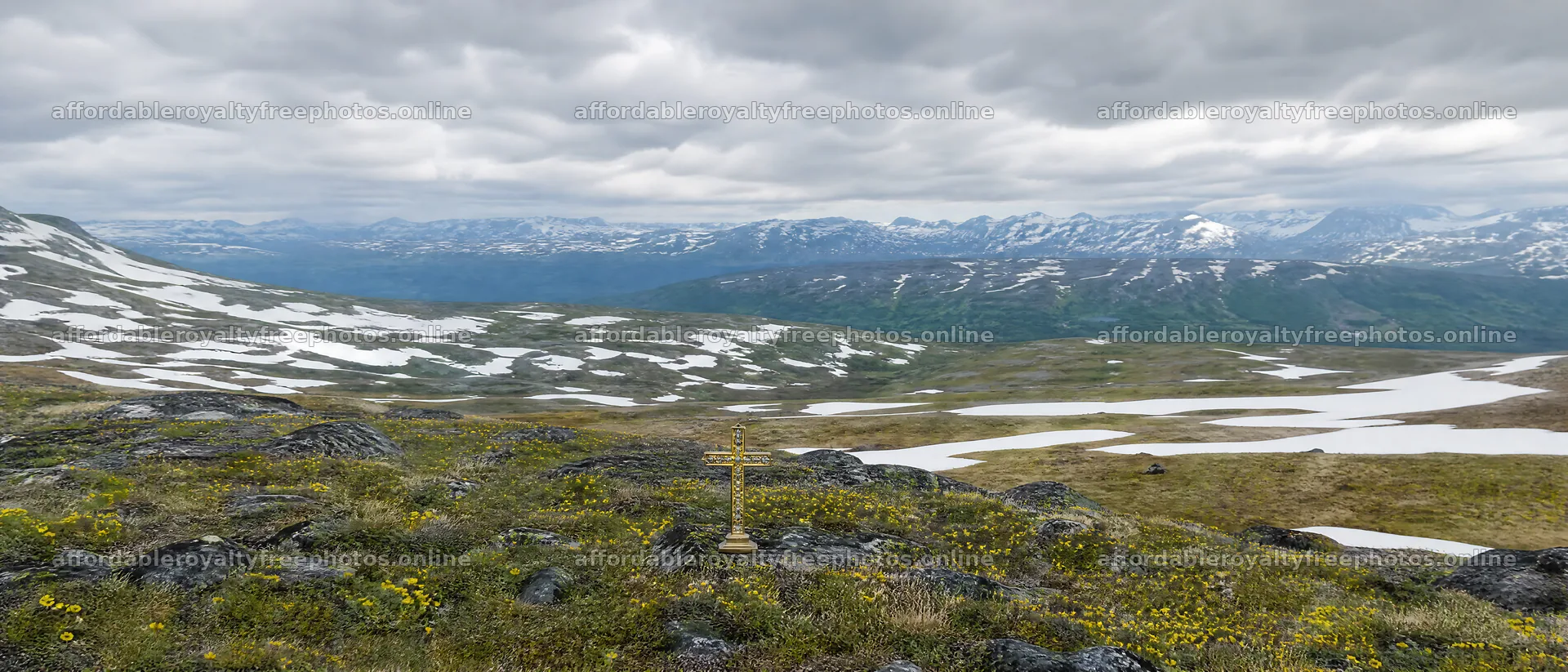 Christian cross in deep mountain valley with snow and – royalty-free photos 12124x5196