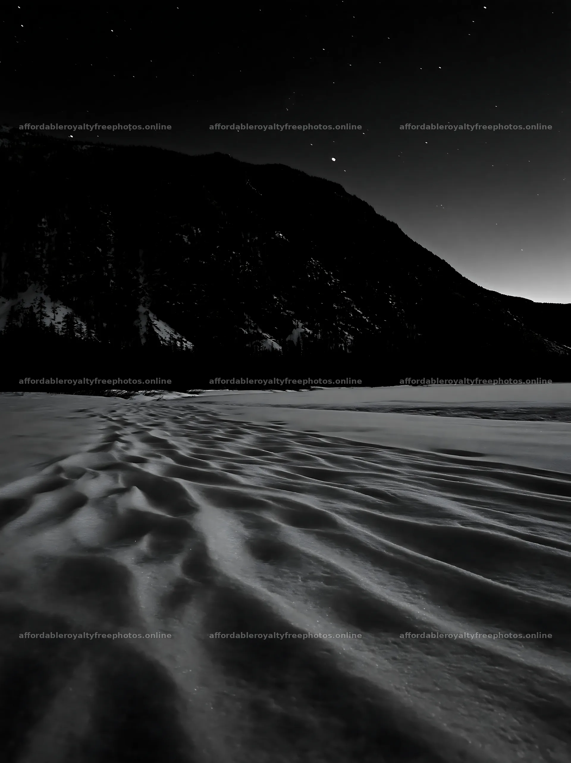 Snowy lakeside meadow with dark mountains and starry sky – royalty-free photos 6866x9174