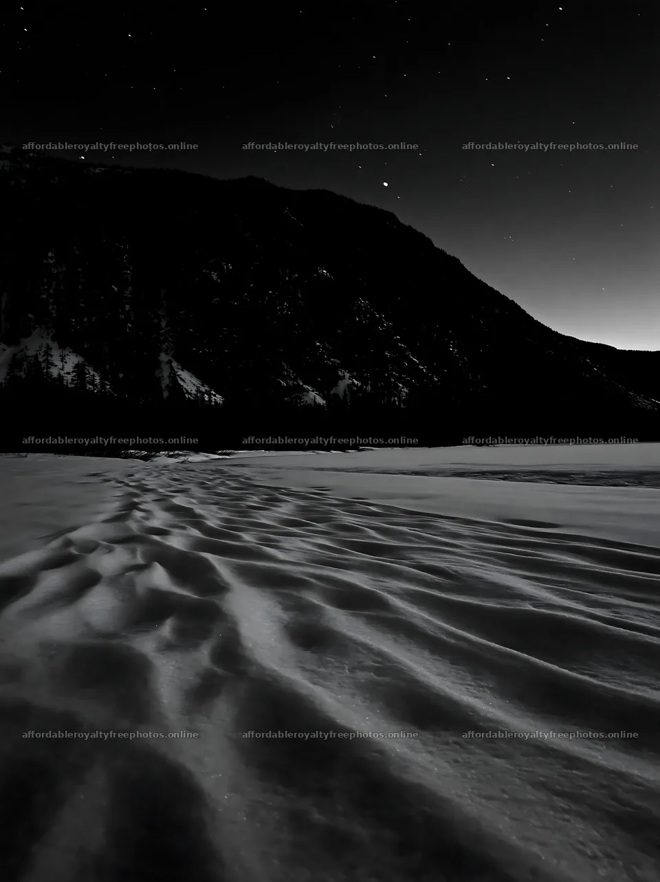Snowy lakeside meadow with dark mountains and starry sky – royalty-free photos 6866x9174