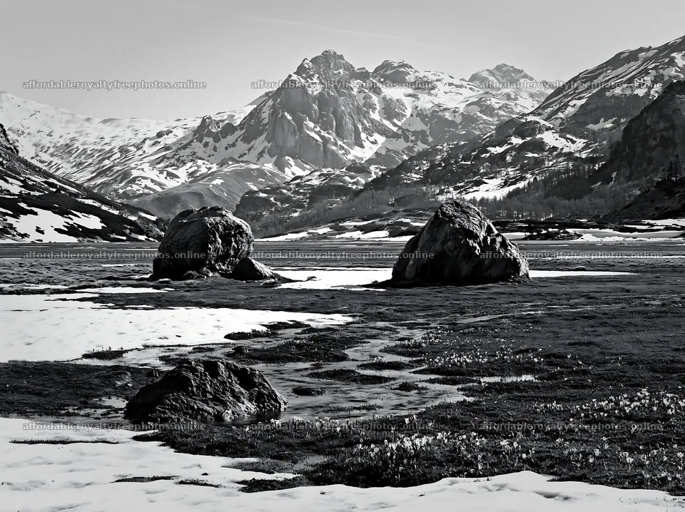 Mountain pass meadow with rocks and snow in black and – royalty-free photos 9174x6866