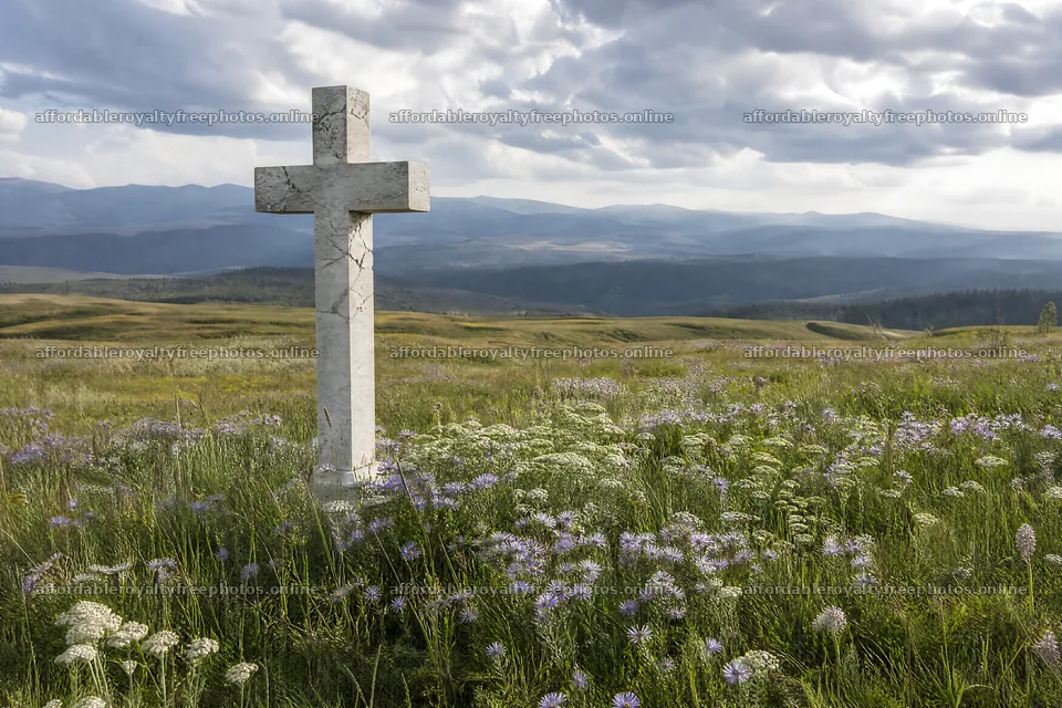Marble cross in a meadow under cloudy sky – royalty-free photos 9722x6480