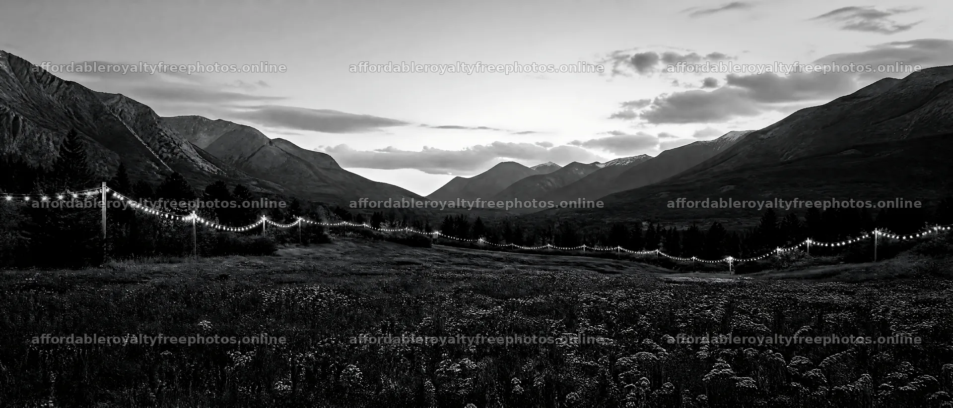 Warm Christmas lights in a mountain valley meadow – royalty-free photos 12124x5196