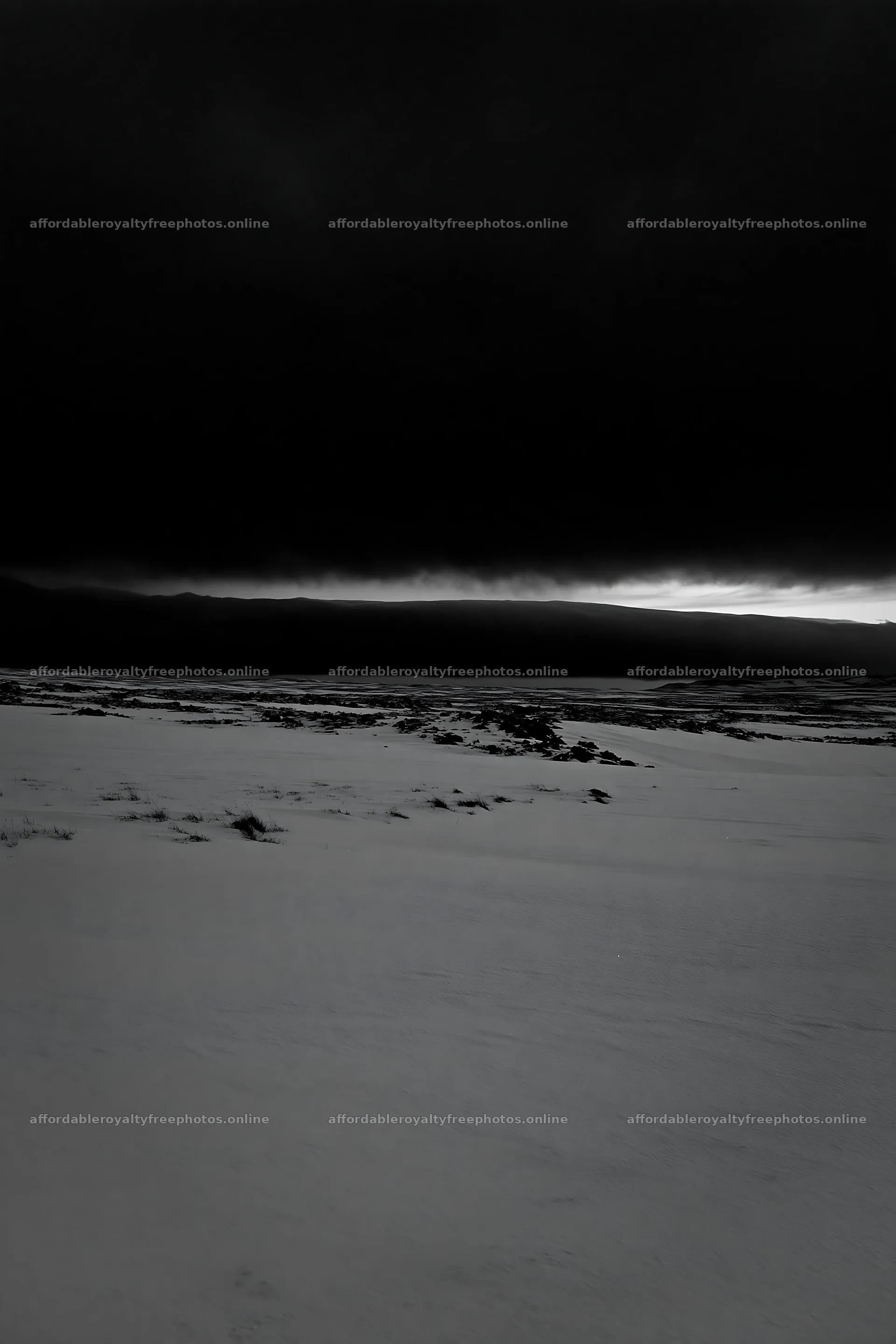 Snowbound meadow under dark clouds – royalty-free photos 6480x9722