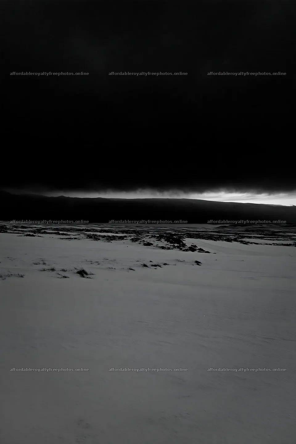 Snowbound meadow under dark clouds – royalty-free photos 6480x9722