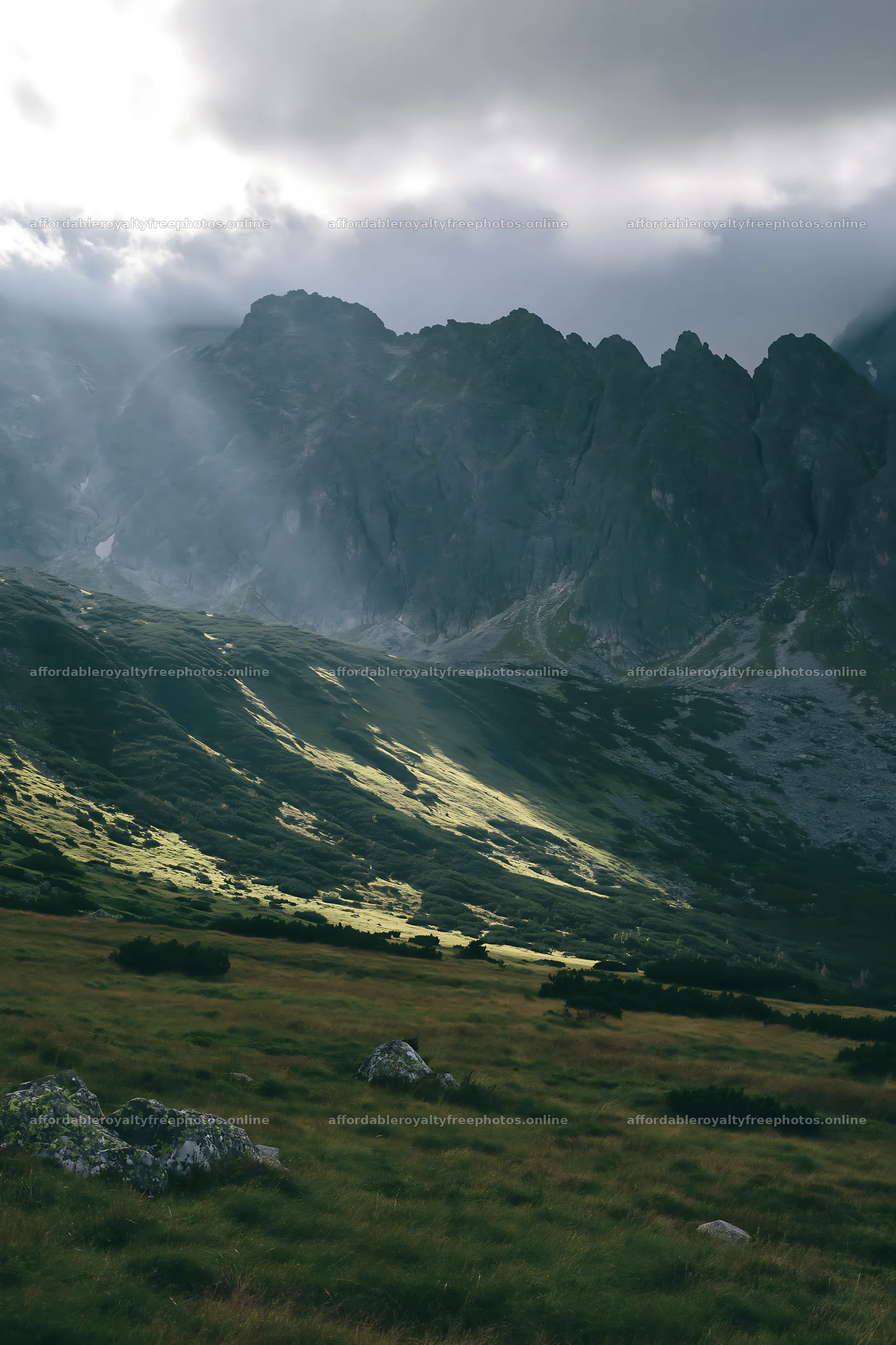 Meadow with mountain views and sunrays breaking through – royalty-free photos 6480x9722