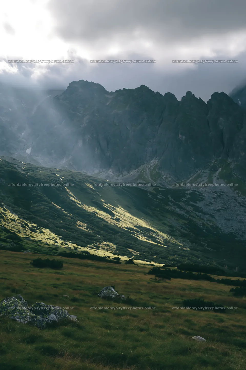 Meadow with mountain views and sunrays breaking through – royalty-free photos 6480x9722