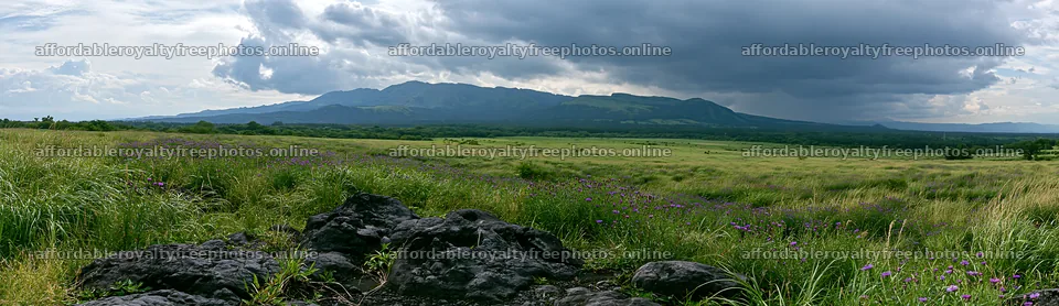 Kumamoto volcanic meadow with dark rocks in the – royalty-free photos 14762x4268