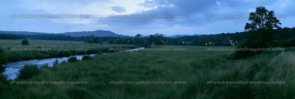 Christmas lights at dusk beside stream in meadow – royalty-free photos 13690x4602